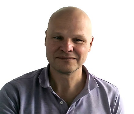 A person in a purple shirt Description automatically generated