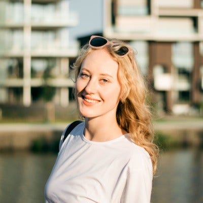 A person smiling at the camera Description automatically generated