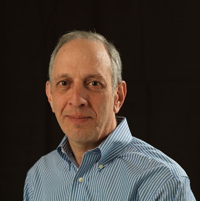 A person in a blue striped shirt Description automatically generated