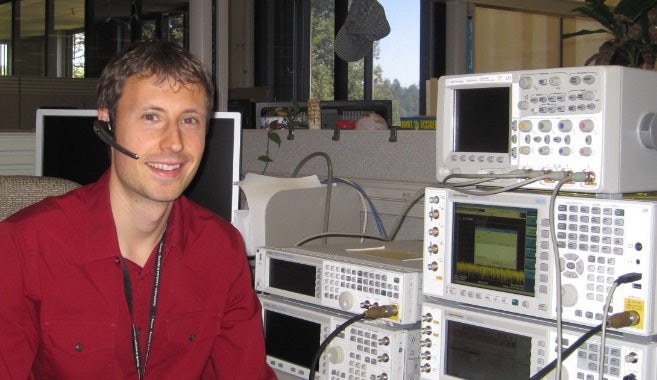 A person sitting in front of several electronic devices Description automatically generated