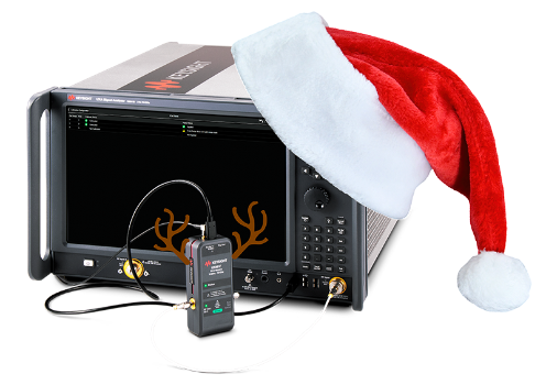 Signal analyzer with santa hat on attached to a calibration tool