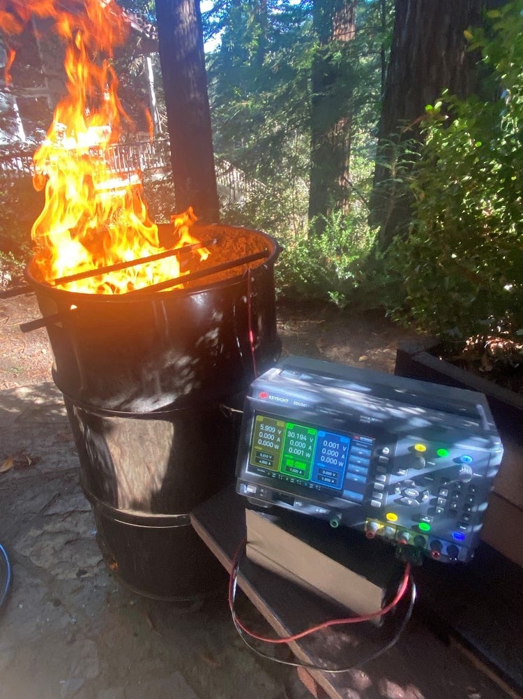 a power supply next to a burning trash can