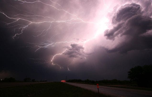 Lightning striking above a road