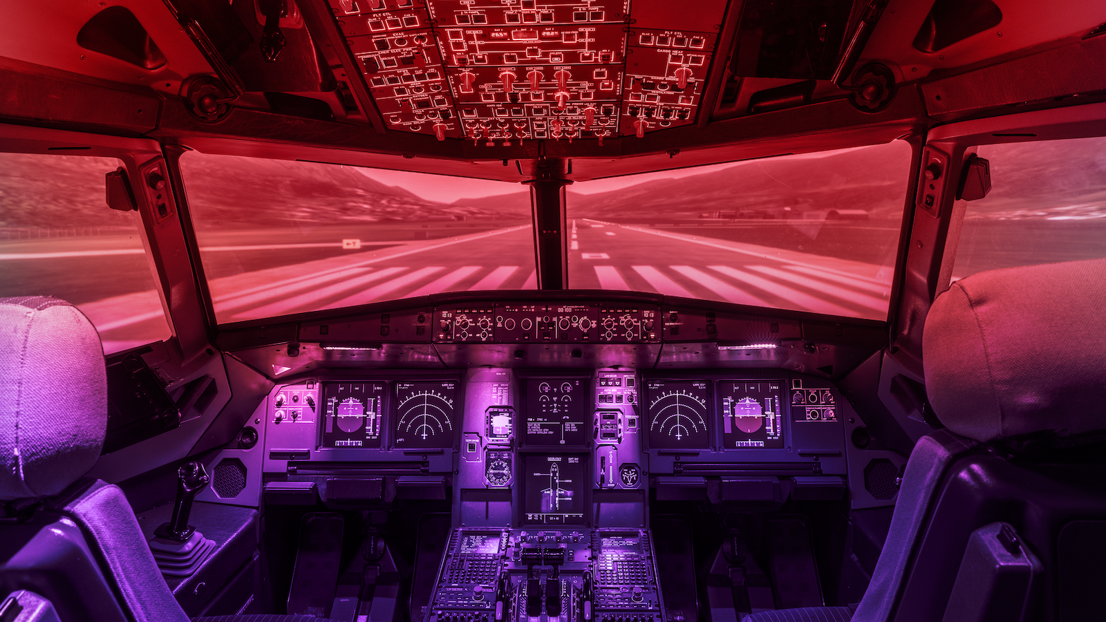 View of runway from inside of plane cockpit