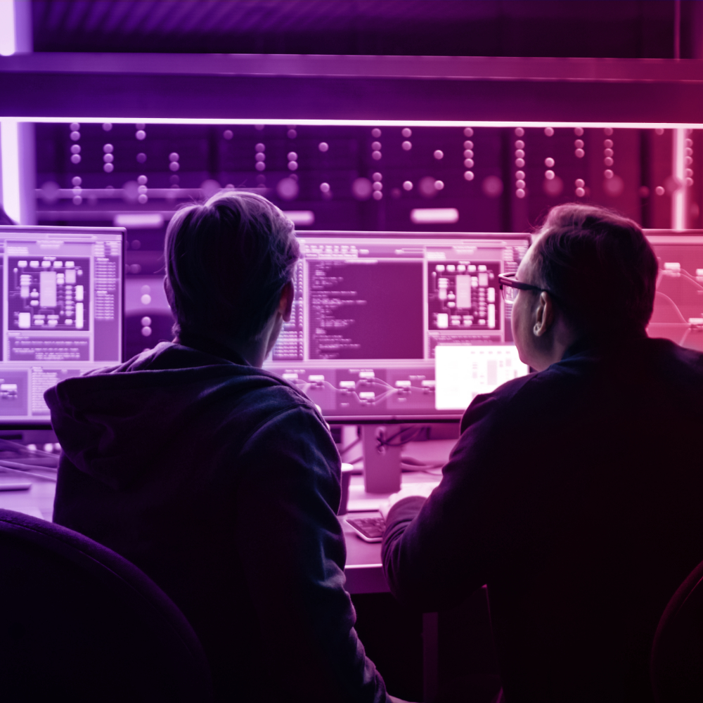 two engineers in front of computer screens