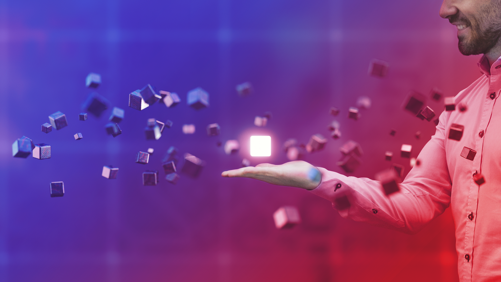 Person holding a bright cube, with other cubes floating around it