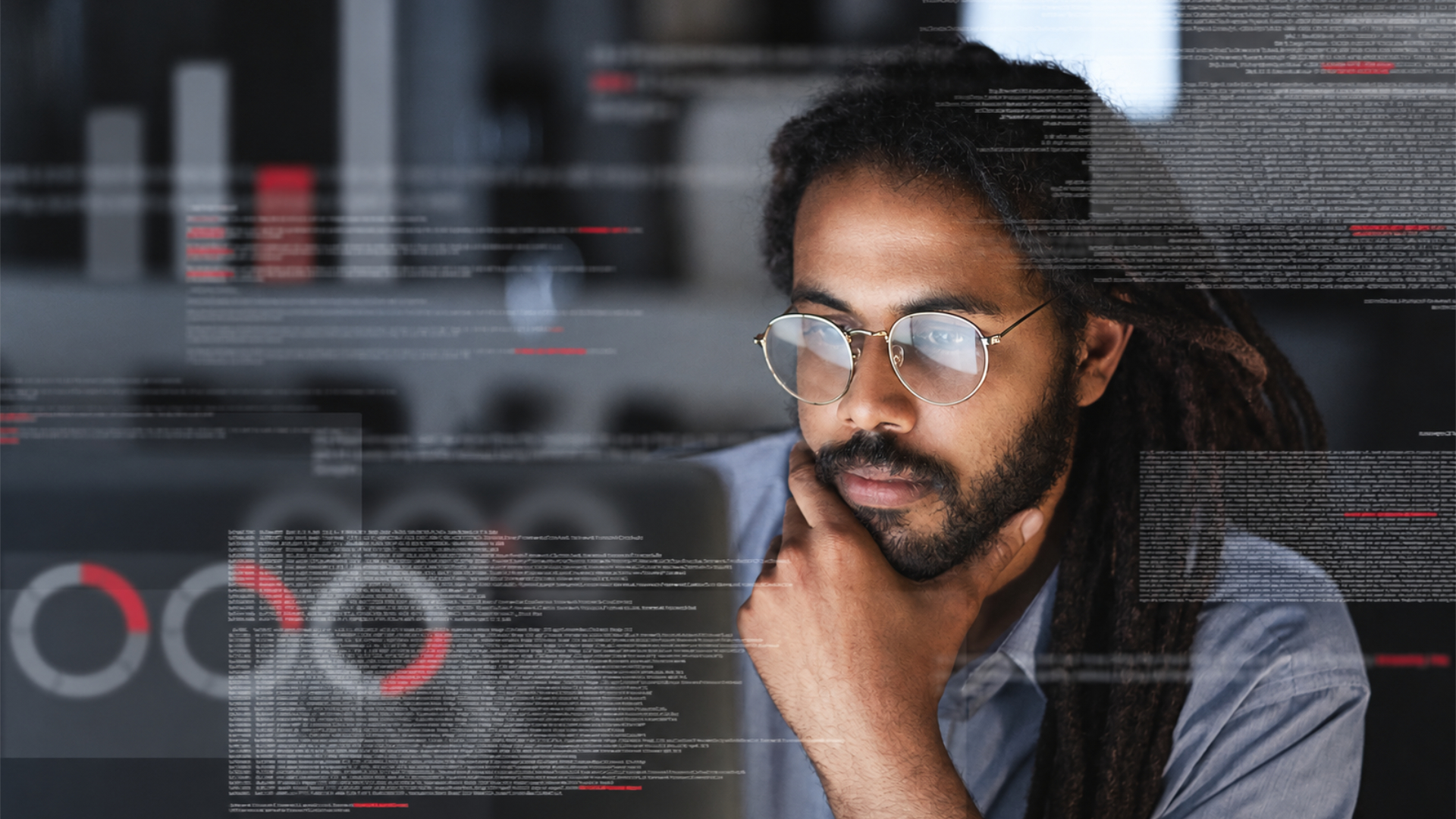 Man looking at graphs on screen