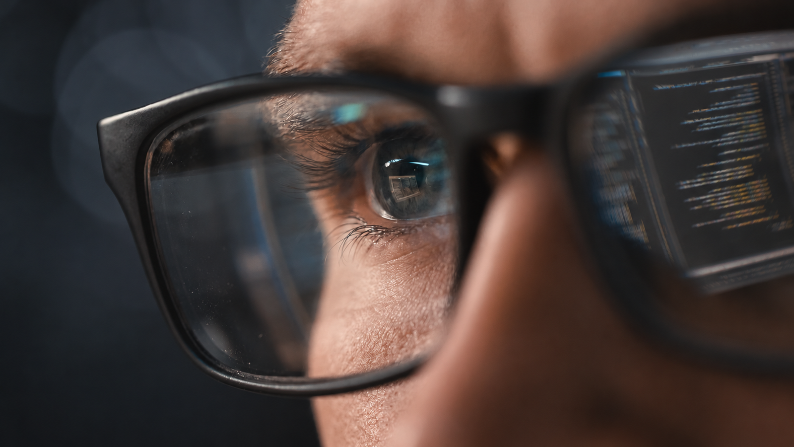 Close-up of glasses showing screen reflection