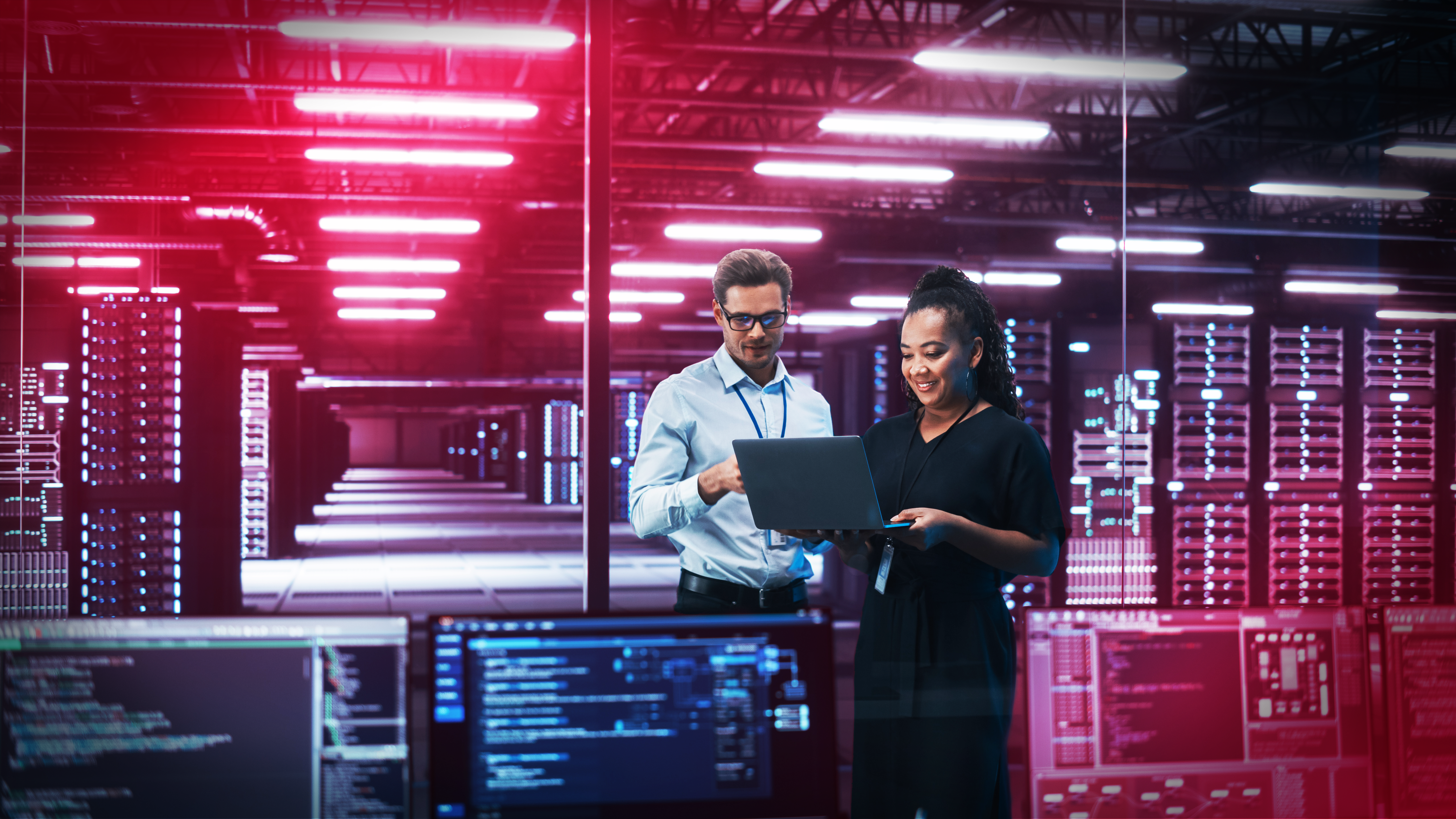 Two engineers working together in a data center.