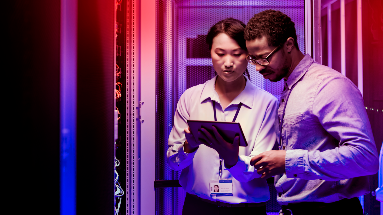 Two GNSS test professionals viewing a tablet