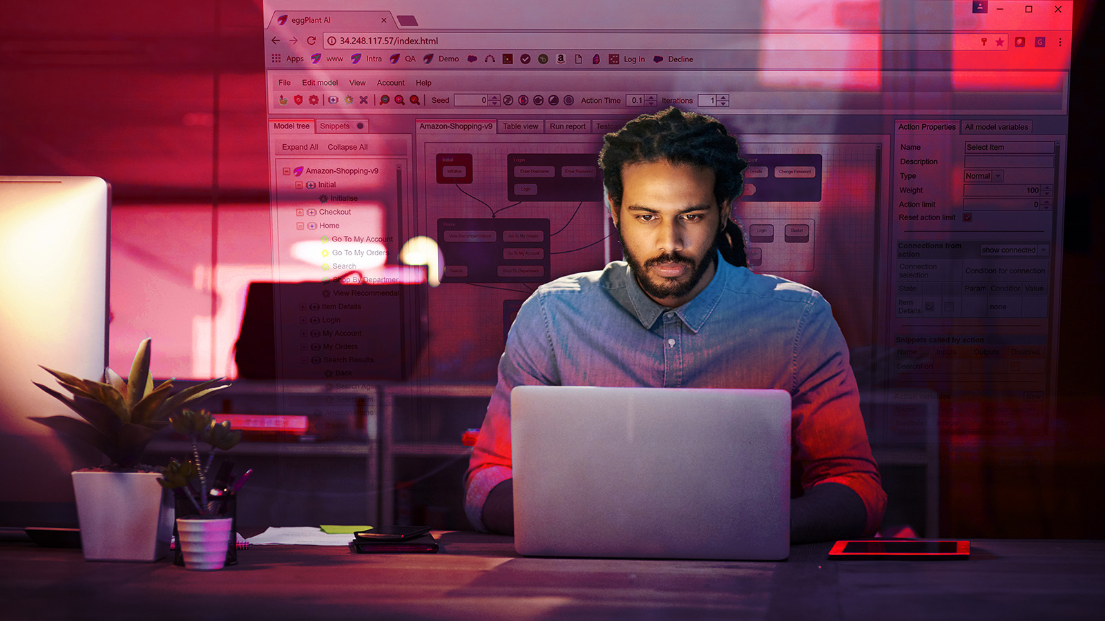 Two developers sit in front of computer with one pointing at screen